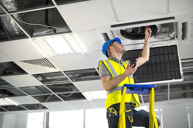 Man installing lighting fixture